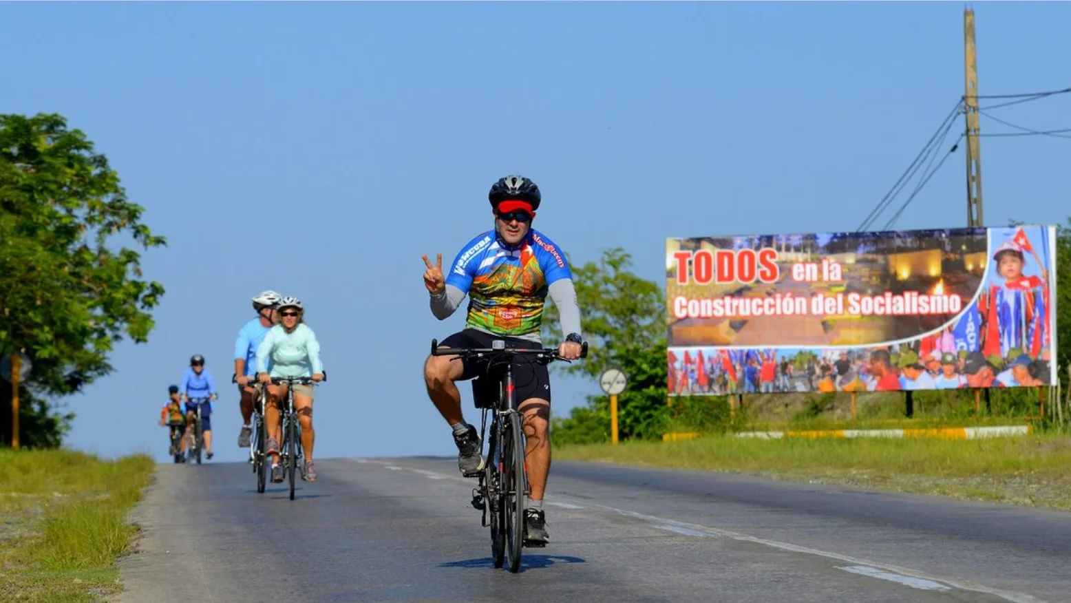 Cyclists travelling along a road in Cuba