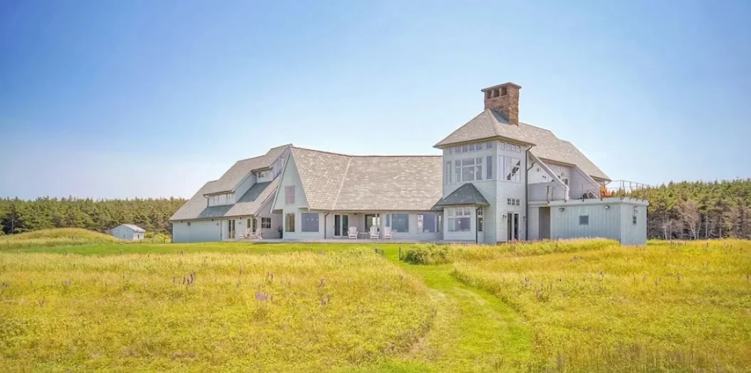 A pale wooden building beside the sea