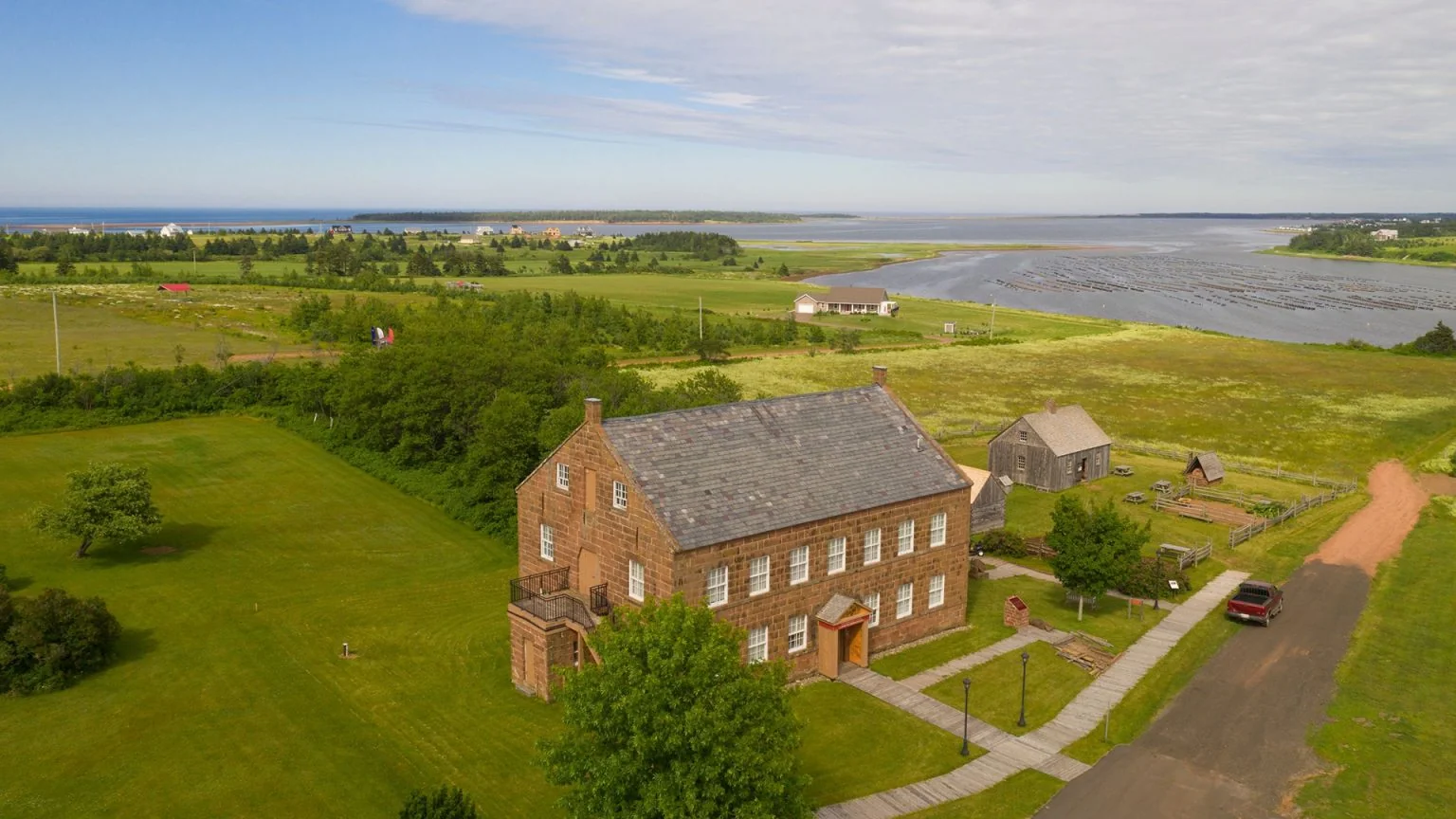 Historic stone building overlooking coastal grasslands