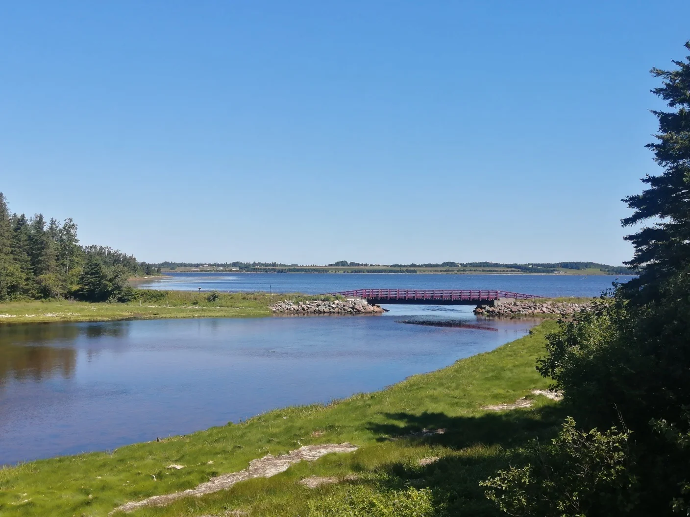 Calm water and a bridge in the distance