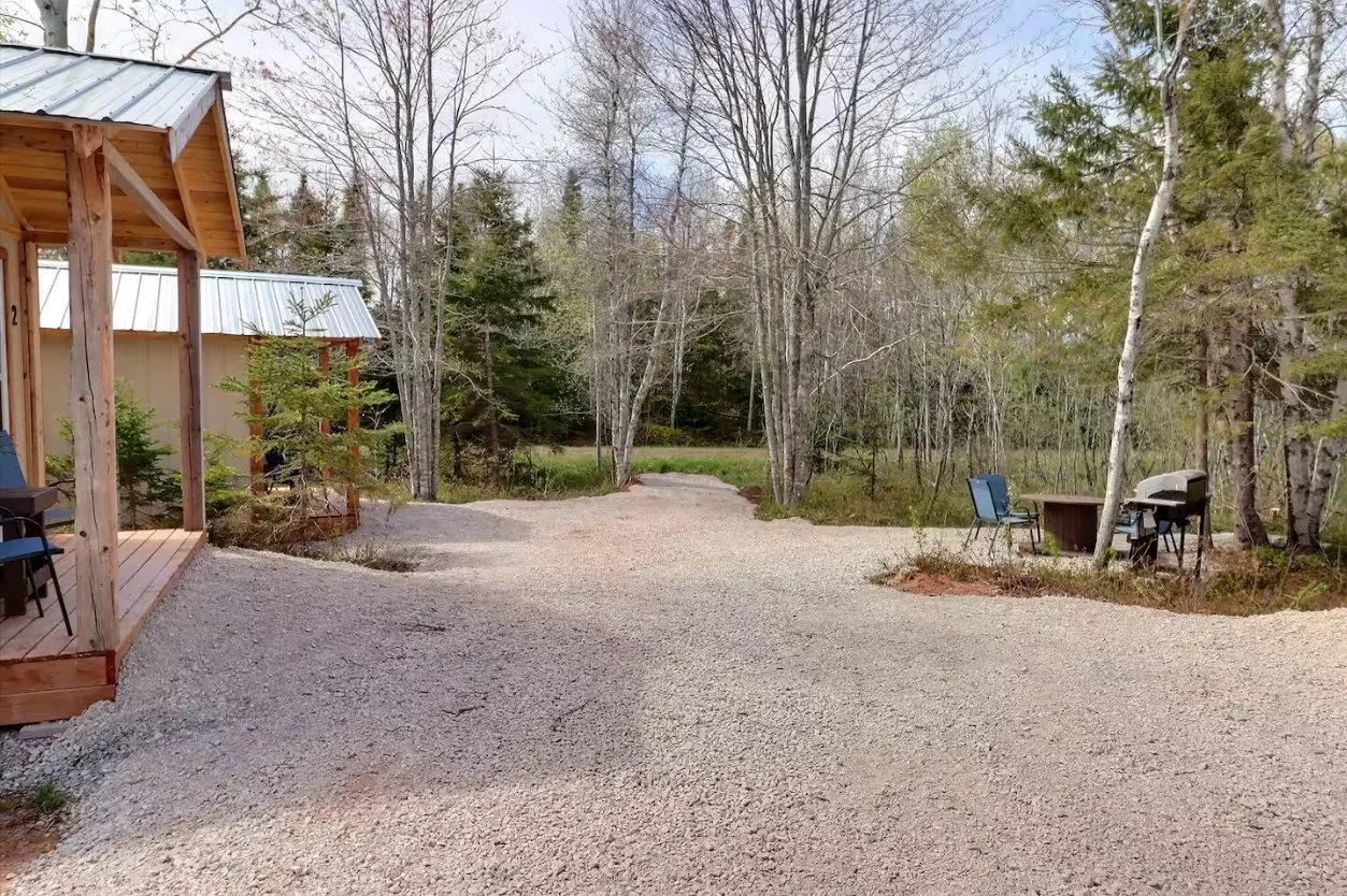 A quiet wooded path beside a timber building